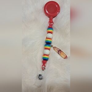 ❤️ B4BB “Root & Radiance” Badge Reel – Red Base, Rainbow Stripe & Feather Charm